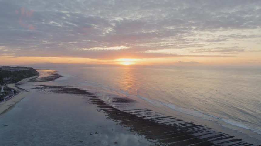 The sun sets on an ocean horizon