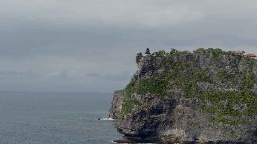 Buildings on cliff near ocean