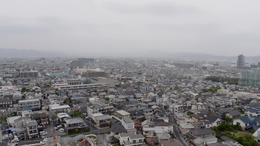 Fogs sets over a dense city filled with homes and high rises