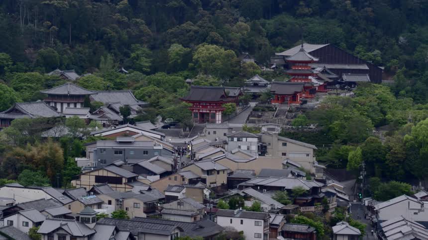 A japanese town packed with small buildings moves by
