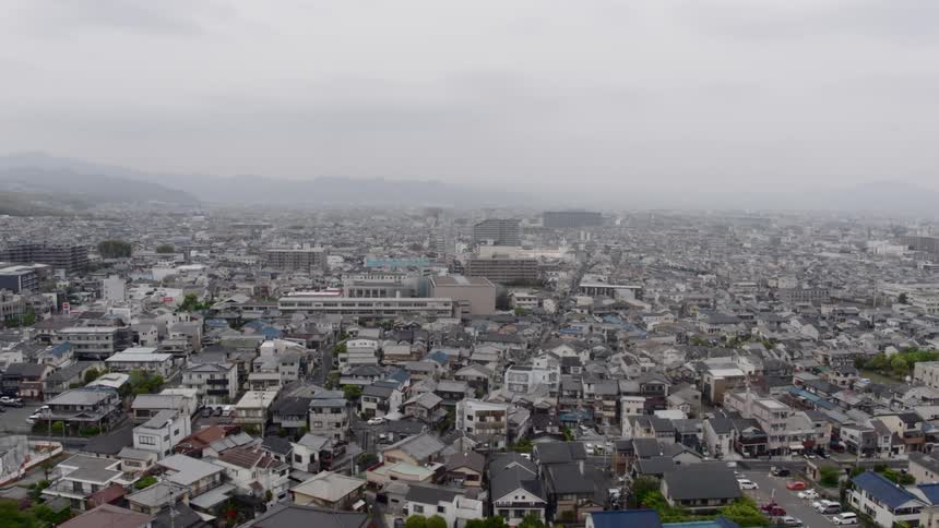 The camera flies over a dense residential area