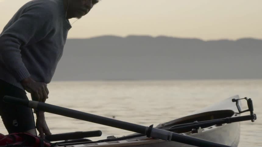 A person gets a rowboat ready
