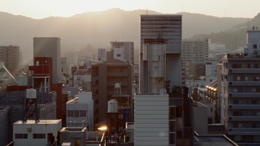 A city crowded with buildings moves by