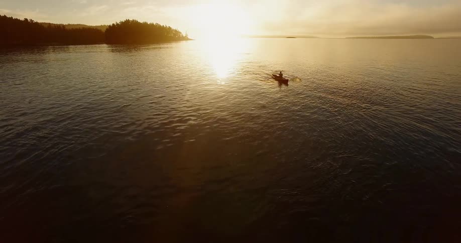 A person is crossing a large body of water in a rowboat