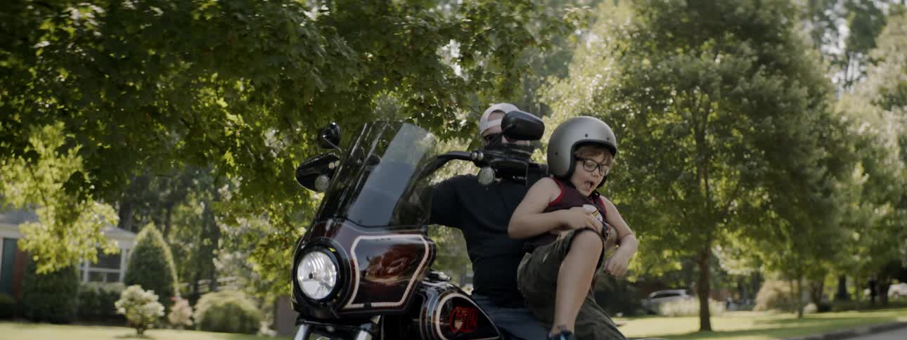 Boy lifted off of motorcycle by man