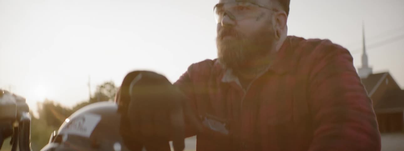 A close up shot of a man on a motorbike