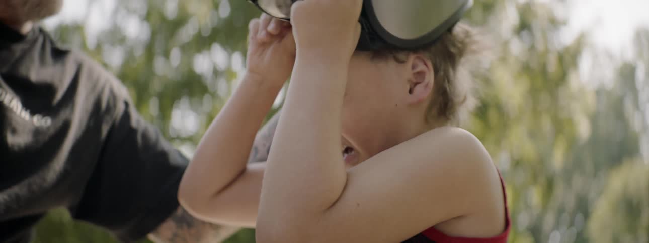 Father helping son to take off helmet