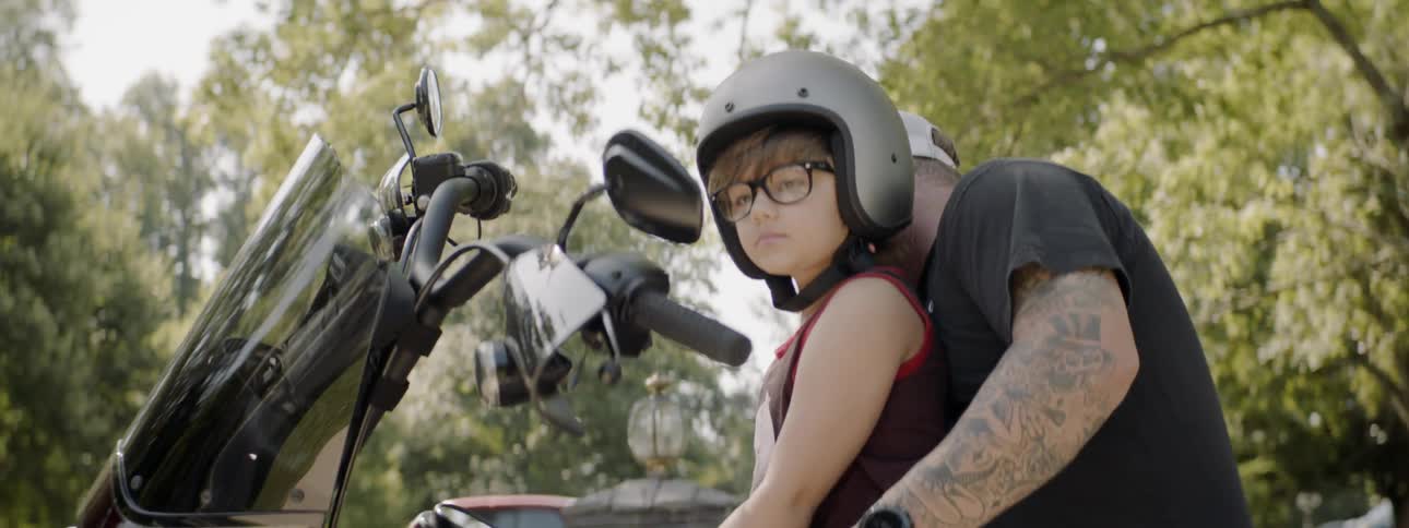 Boy and grandpa sitting on a motorcycle