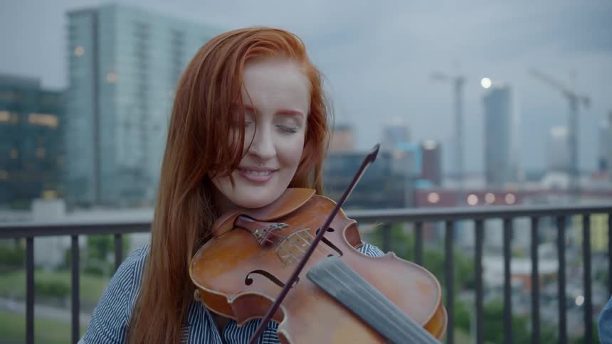 Woman plays violin on street