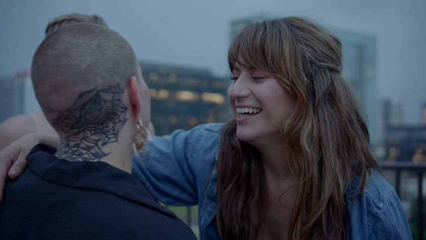 Musician hugs woman