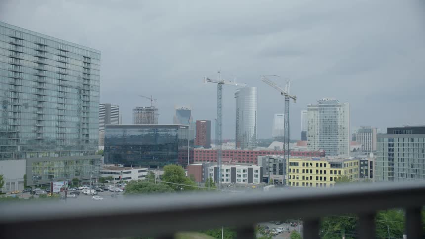 The camera looks out at a cityscape