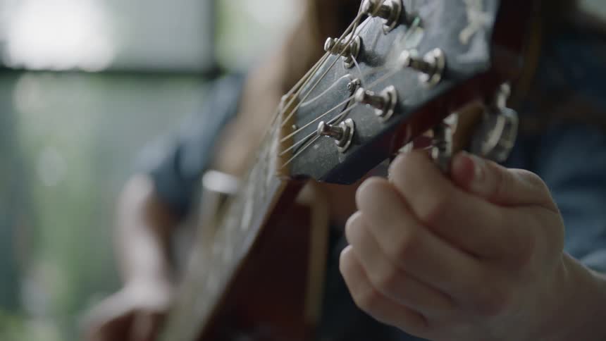 A person tuning a guitar