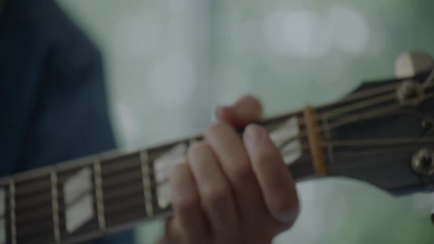 A woman plays the guitar