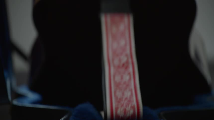 A person lifting a guitar from a guitar case