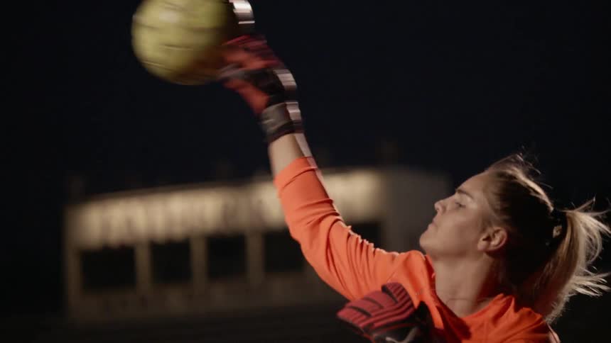 A young girl throws a ball