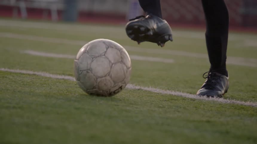 A woman intercepts the ball in a soccer match