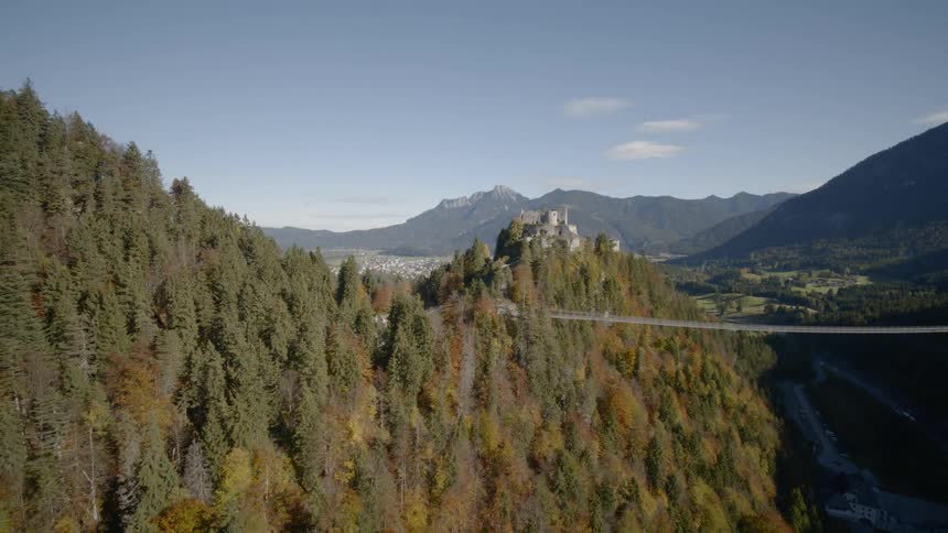 The camera flies in a canyon looking at a bridge