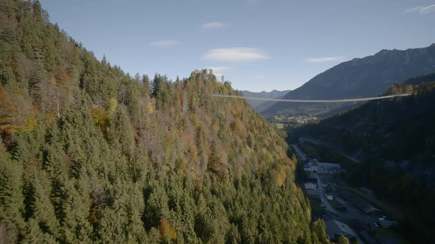 Aerial view of a forest with buildings in the valley below