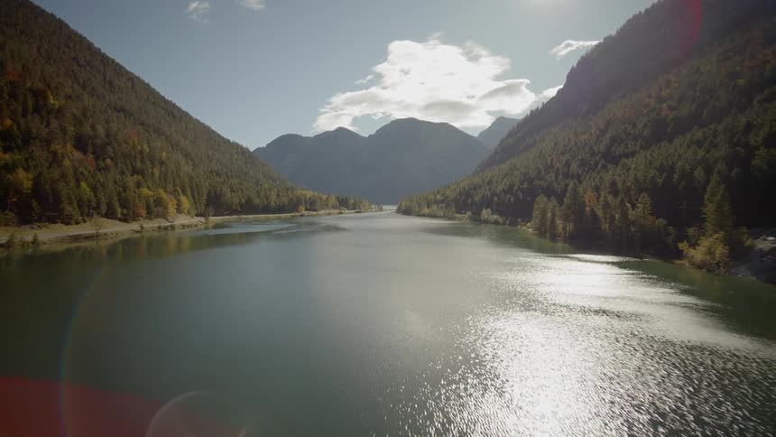A reservoir is surrounded by mountains and forest