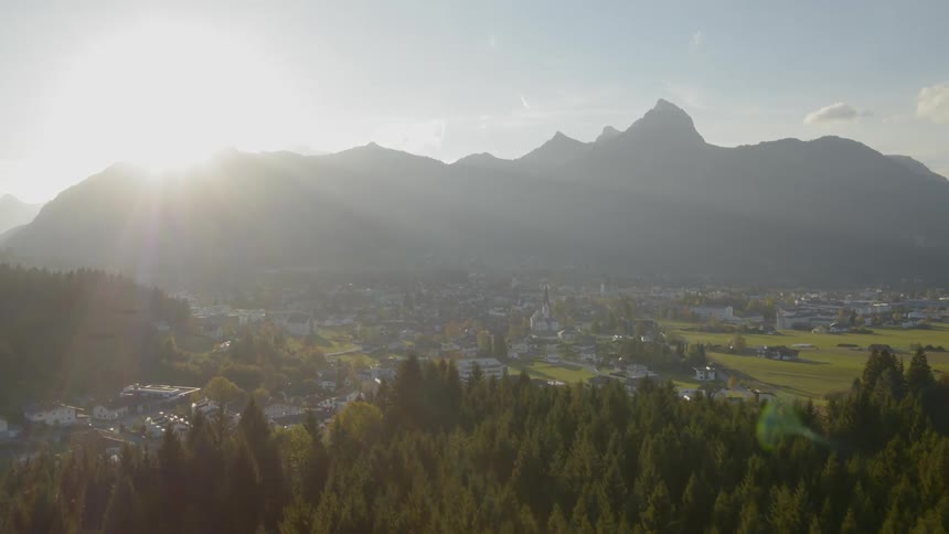 Landscape of the small town while the sun goes down behind the mountain