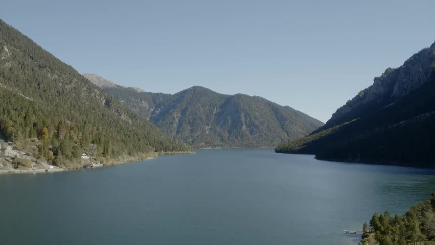 A clear lake is nestled in a mountain range