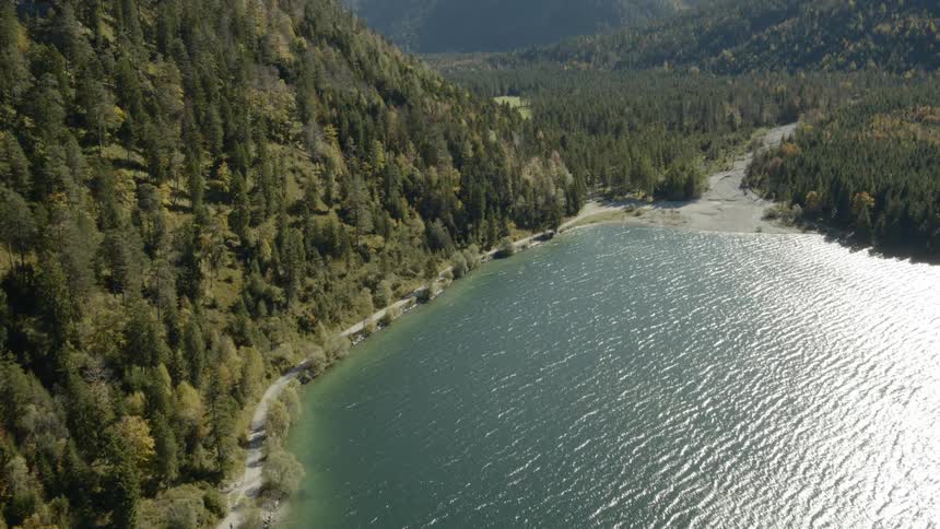 An aerial view of a road running along a river