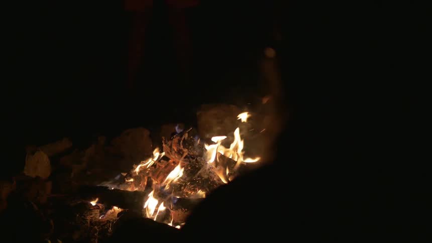 A fire burns at night
