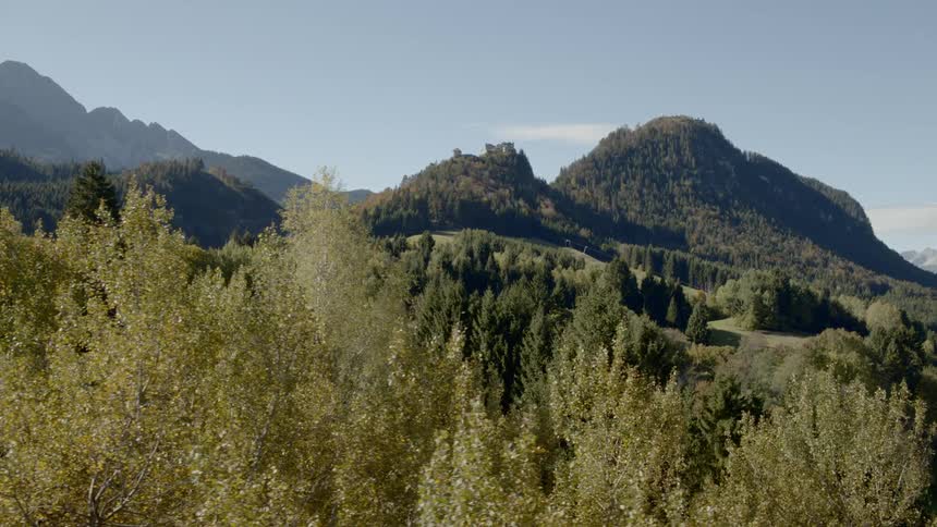 It is an aerial view of the path winding up the green mountain