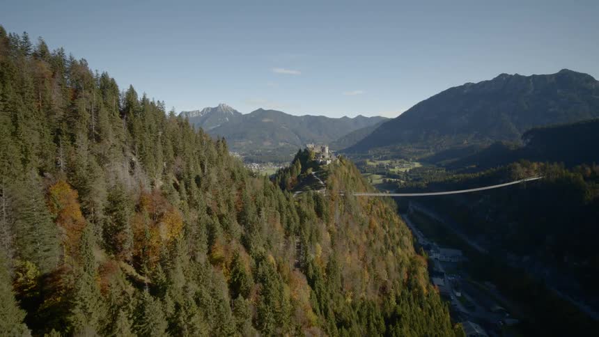 Aerial view of a forest with a valley with buildings below