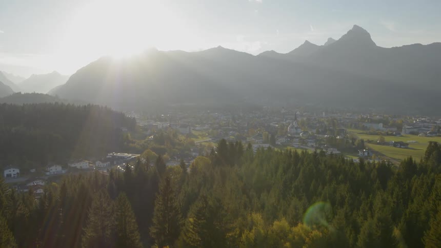 Landscape of small town while the sun goes down behind the mountain