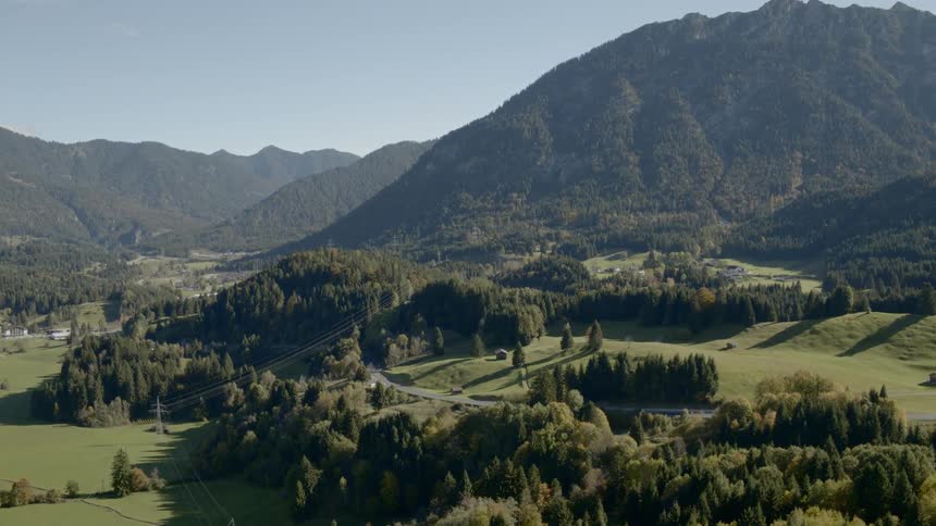 Trees and grass in front of a mountain range