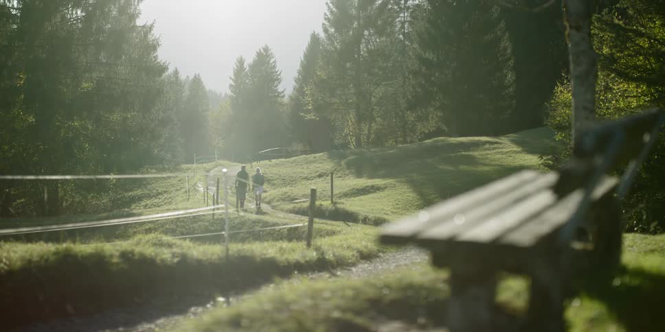 Couple walk along trail in park