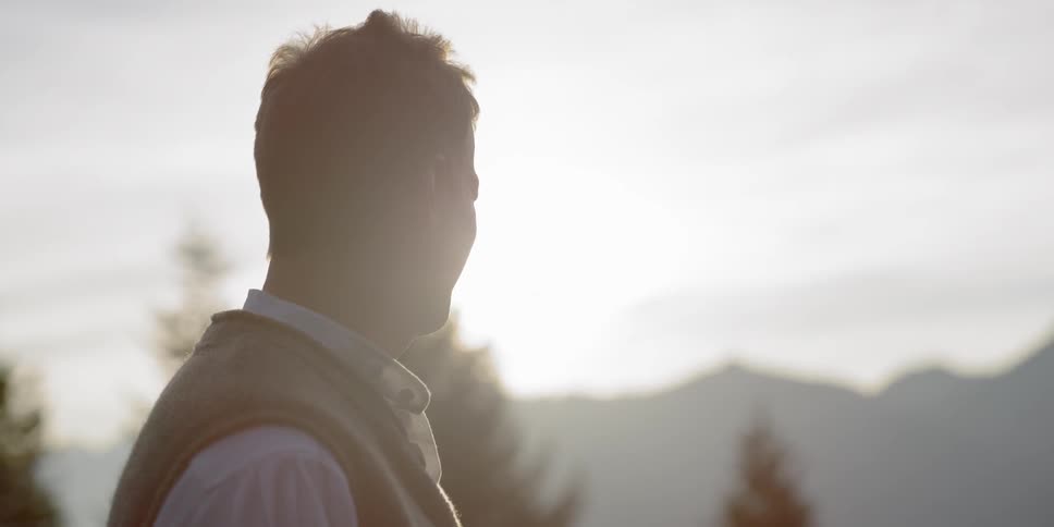 A white man looks around outdoors