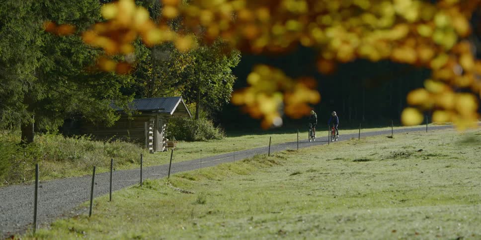 Couple biking riding on a gravel path in the countryside