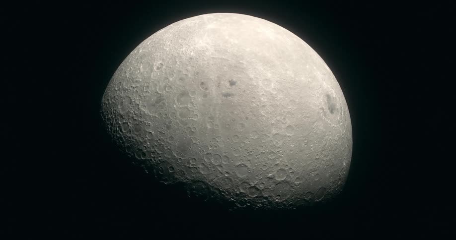 In the darkness of outer space the crater covered surface of the Moon can be seen slowly rotating