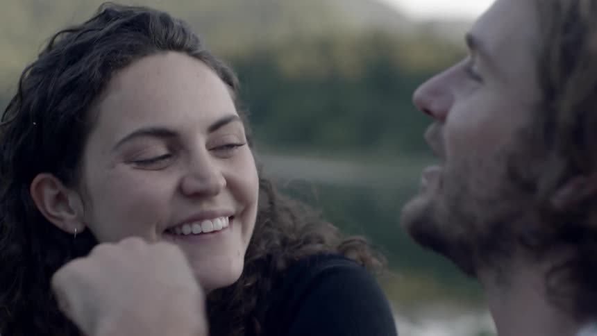 A man and a woman talking while sitting outdoors