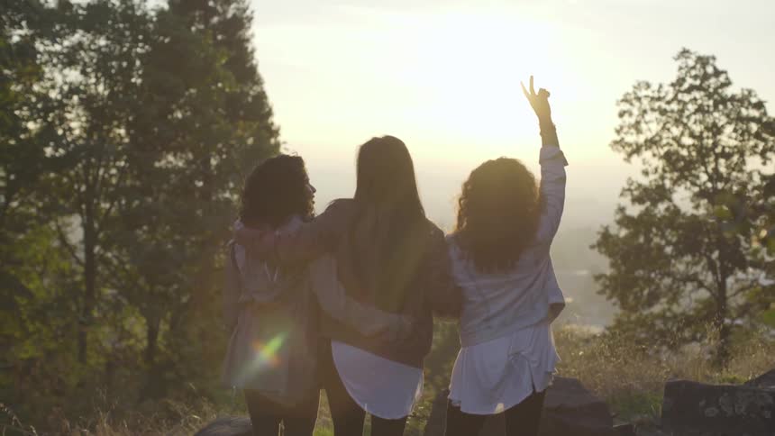 Three women stare at the view together