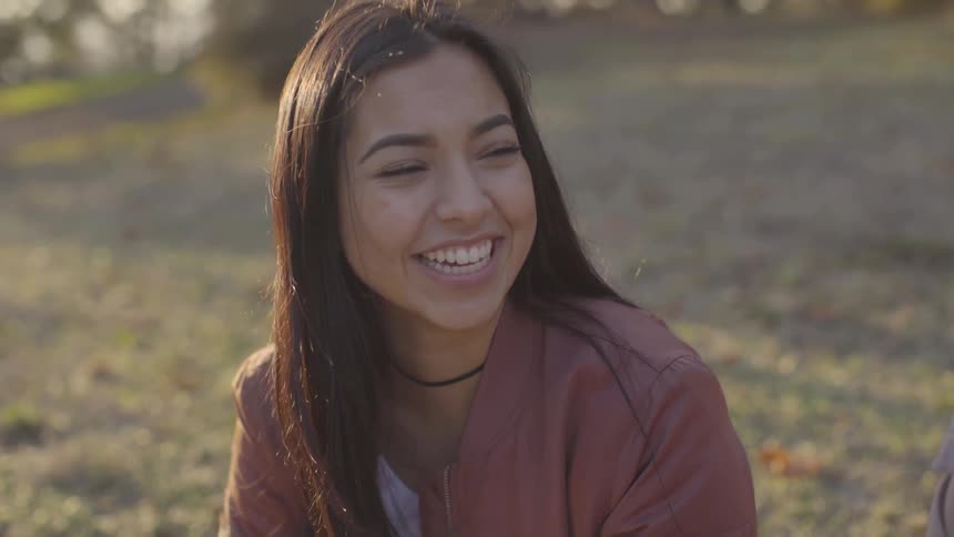 Girl laughing sitting on the ground