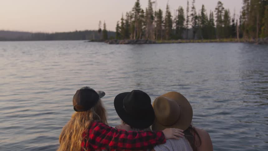 A group of people look out over a lake