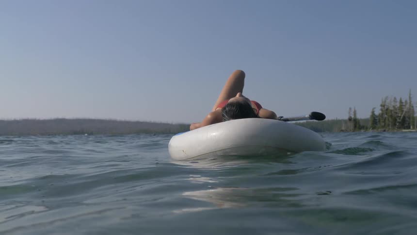 A woman floats on her flotation device