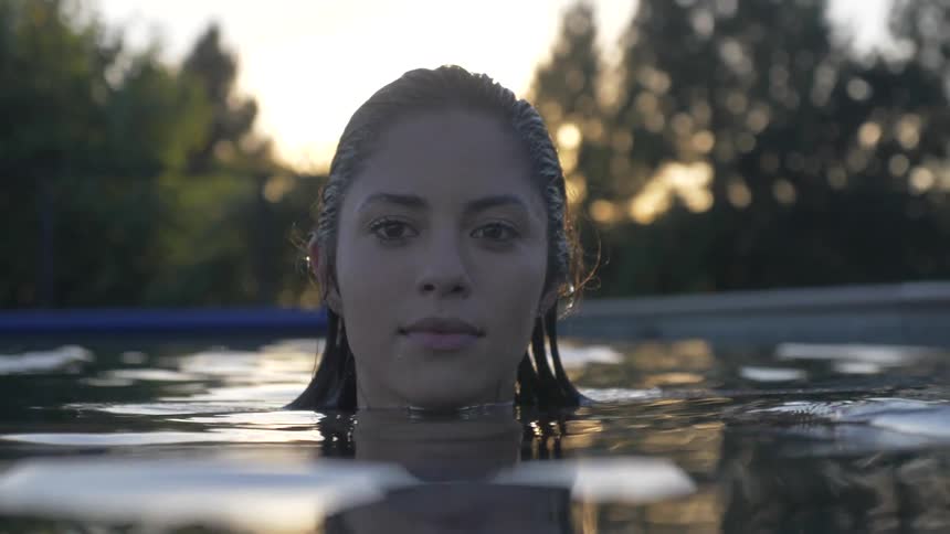 A woman bobs in a pool
