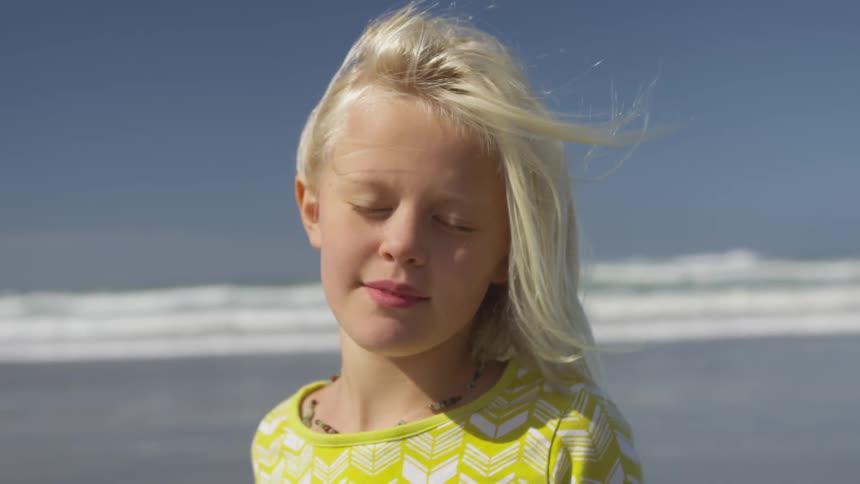 Blonde girl stands on beach