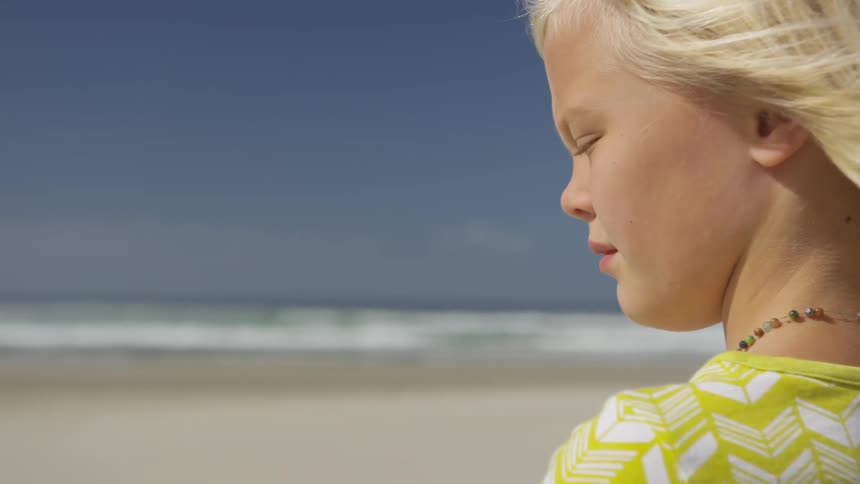 A woman stands at the beach