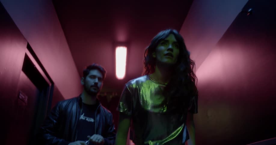 A man and a woman walking down a hallway