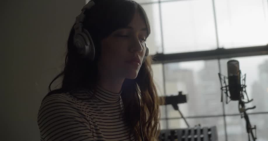 Woman listening to music and working on computer