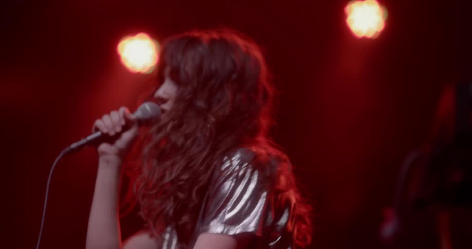 Woman sings on stage