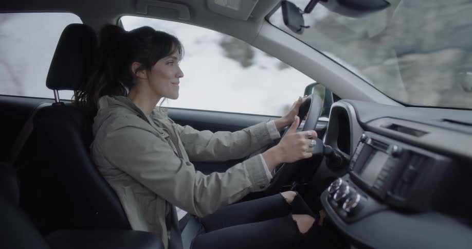 A woman in a car driving