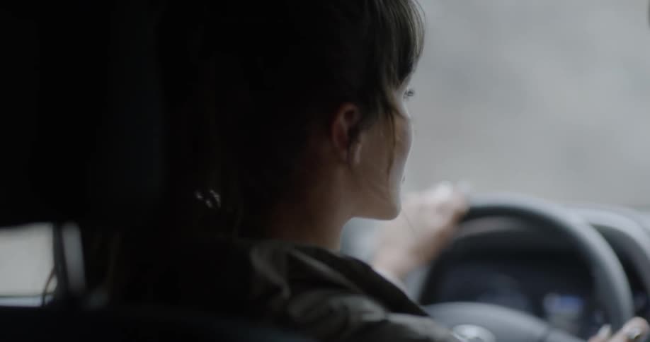 A white woman drives a vehicle