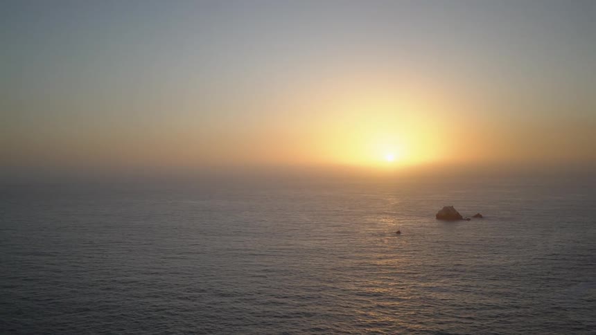 The sun rising over the ocean horizon