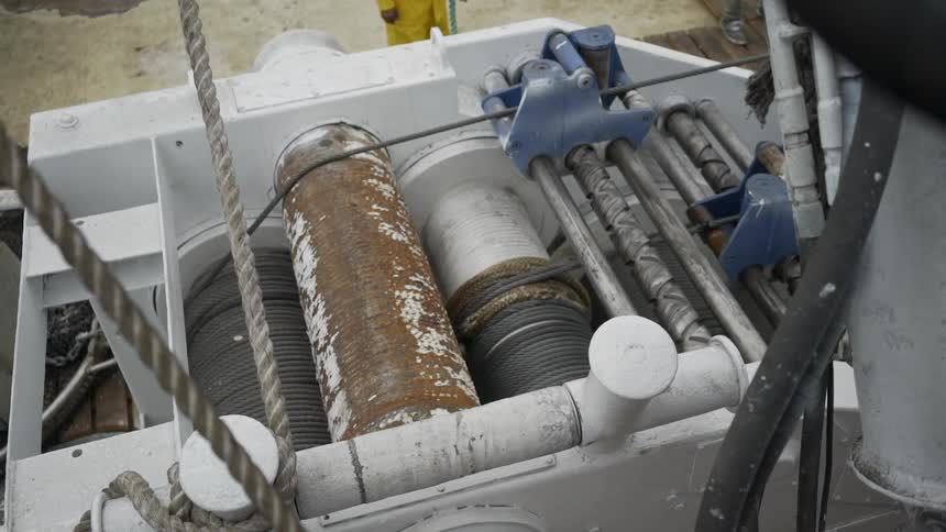 Wire rope pulling electric winch rolls wire during daylight